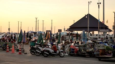 CHONBURI, THAILAND - 14 NOV : Motorcycles parking beside street market with sunset sky on 14 November 2020 in Bangsaen, Chonburi, Thailandのeditorial素材