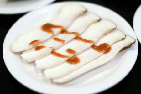 Raw mushroom with sauce in white dish for BBQの写真素材