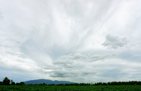 Clouds in sky with farm foreground, Agriculture landscape nature backgroundの写真素材