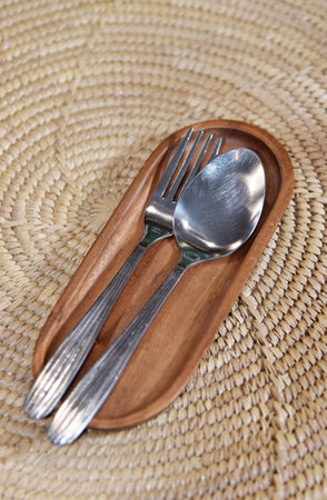 Spoon and fork in wooden tray, Close up shotの写真素材
