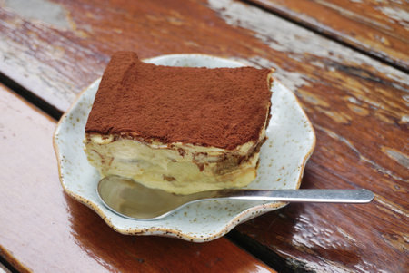 Tiramisu cake on wooden tableの写真素材