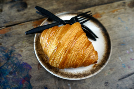 Croissant in dish, Nice dessert on wooden tableの写真素材