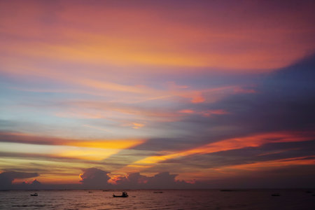 Nice sunset ray shine on clouds sky with sea backgroundの写真素材