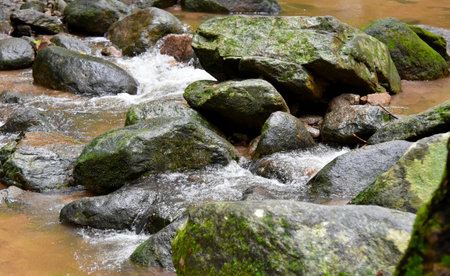 Water from the waterfall splashes against the rocks