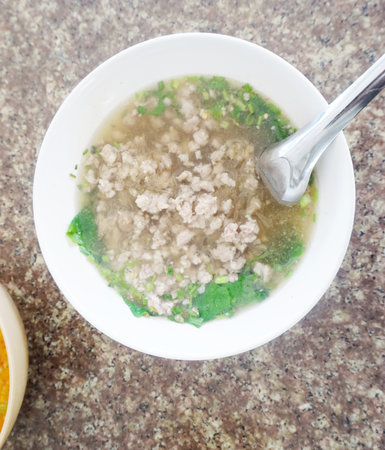 Close up shot of clear soup with glass noodles and minced pork, Thai food