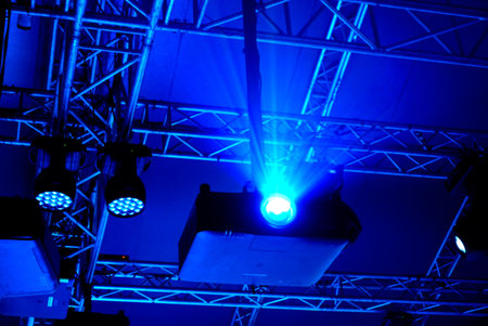 Stage lighting with blue beams at dark hall