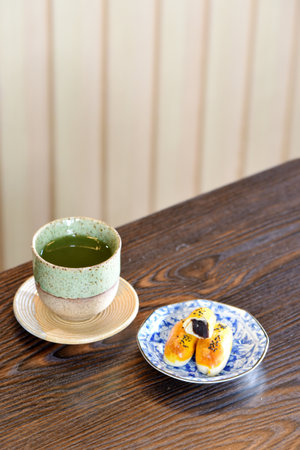 Hot Matcha green tea cup with Chinese pastryの写真素材