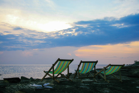 Beach chair with sun flare twilight timeの写真素材
