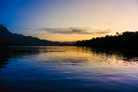 Sunset Scene with Beautiful lake and mountain background at Ratchaprapa dam , khao sok national park ,Thailandの写真素材
