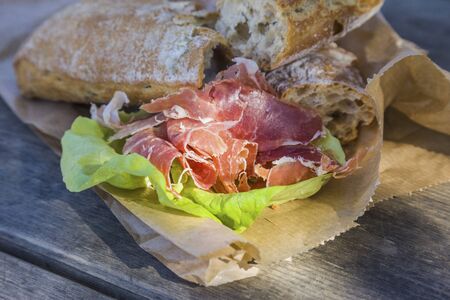 outdoor snack of bread and smoked meatの写真素材