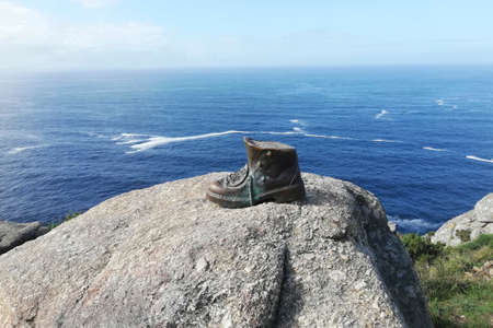 Bronze boot in Finisterra, on the cape, by the sea. Camino de Santiagoのeditorial素材