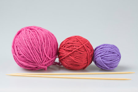 Three colorful balls of yarn for hand knitting with needlesの写真素材