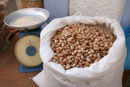 Nuts, pistachios in a bag on the counter in the bazaarの写真素材