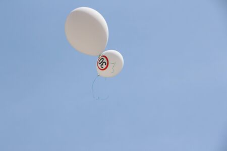 White air balloon against a blue skyの写真素材
