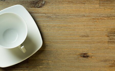 Empty cup on wooden board or table