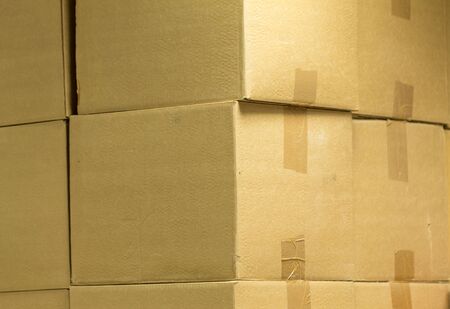 Brown different cardboard boxes arranged in stack. texture. background. Tape mounted. Transportation bagsの写真素材