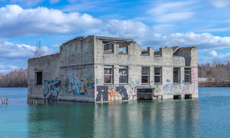 Abandoned sunken ruins of Soviet time prison in Rummu quarry, Estonia. Ruins on ex industry place in old stone building.の写真素材