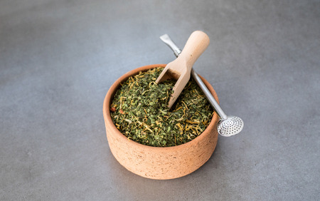 Traditional Yerba Mate tea with matero and bombilla, healthy, energy boosting drink on neutral stone gray backgrundの写真素材