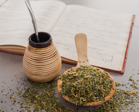 Traditional Yerba Mate tea with matero and bombilla, healthy, energy boosting drink on neutral stone gray backgrundの写真素材