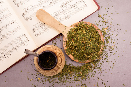 Traditional Yerba Mate tea with matero and bombilla, healthy, energy boosting drink on neutral stone gray backgrund.の写真素材