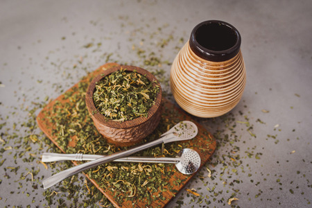 Traditional Yerba Mate tea with matero and bombilla, healthy, energy boosting drink on neutral stone gray backgrund.の写真素材