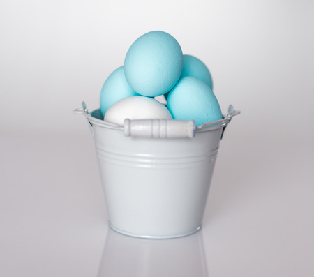 Spring and Easter holiday concept. Easter eggs painted blue and white, pastel color backgroundの写真素材