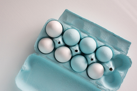 Spring and Easter holiday concept. Easter eggs painted blue and white, pastel color background....
