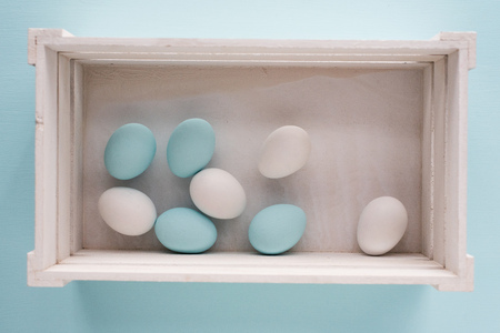 Spring and Easter holiday concept. Easter eggs painted blue and white, pastel color background. Isolated on white.の写真素材