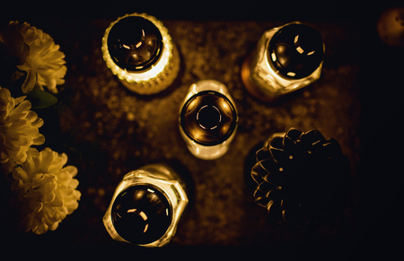 The cemetery, candles burning in the night during All Saints Day, bokeh of light candle.