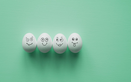 Painted Eggs with cute hand drawn funny faces. Happy easter card concept.