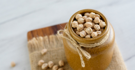 Portion of Chick Peas in ceramic bowl on table. Natural vegan food.の写真素材