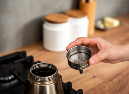 Preparing a traditional italian style coffee with coffee percolator.