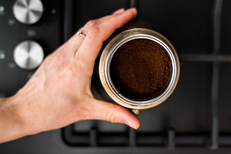 Preparing a traditional italian style coffee with coffee percolator.