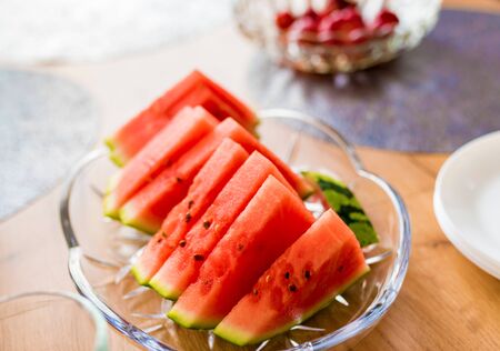Fresh cut of watermelon slices in a glass bowl. Vegan & vegetarian party. Kids party. Healthy lifestyle.の写真素材