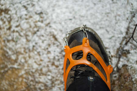 Close up of snow shoes and shoe spikes in winter.