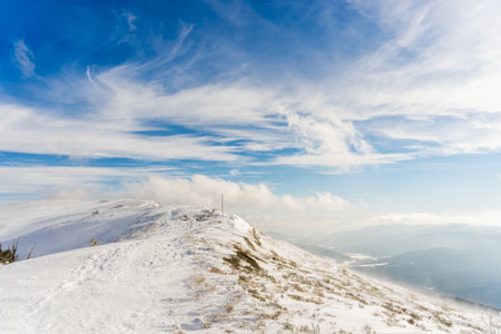 Snowy mountains under blue sky with white clouds. Carpathian, Ukraineの写真素材