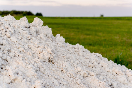 Large pile of white salt in the field at sunset, close-upの写真素材