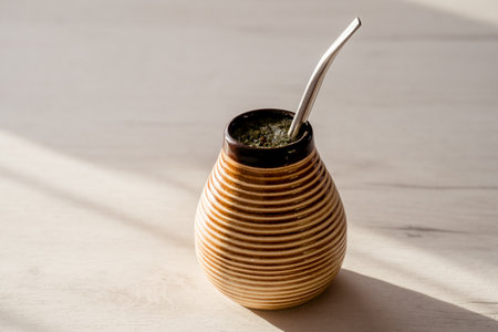 Yerba mate in a ceramic cup on a white wooden table