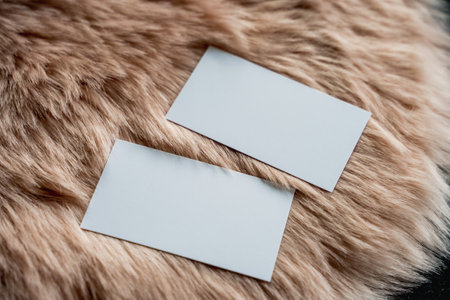 White business cards on fur background. Flat lay, top view.の写真素材