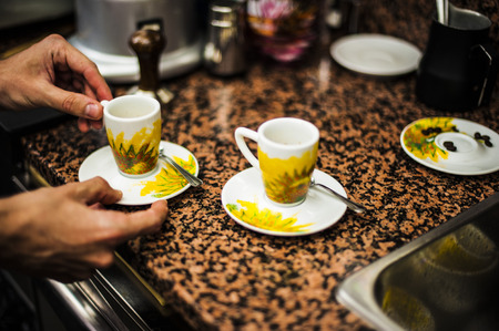 barman serving two original italian coffeeの写真素材