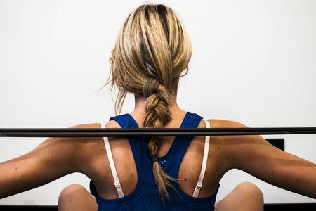 girl making fitness exercises, stretching, weight lifting and abdominalsの写真素材