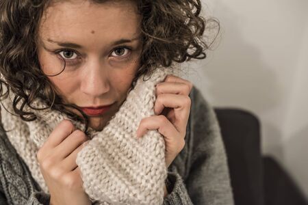 woman with a hot scarf in wool in a gelid winterの写真素材