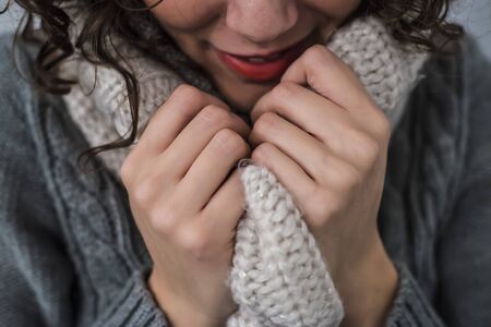 woman with a hot scarf in wool in a gelid winterの写真素材