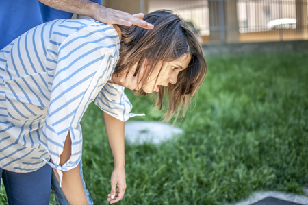 Guy doing the heimlich maneuver to a girl while she's chockingの写真素材