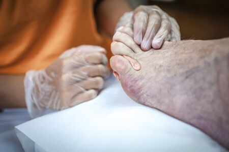podiatry doctor curing an elderly patient footの写真素材