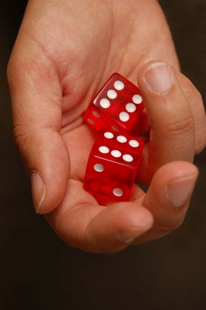 Hand holding two dice (sixes)