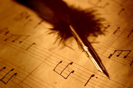 Quill pen on an old handwritten music sheetの写真素材