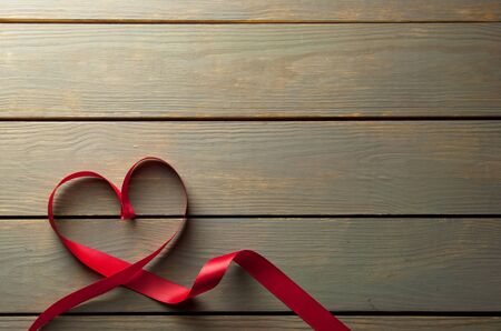 Valentines day red ribbon over a wooden backgroundの写真素材