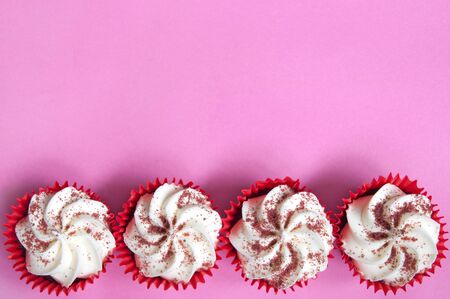 Cream cupcakes over a pink backgroundの写真素材