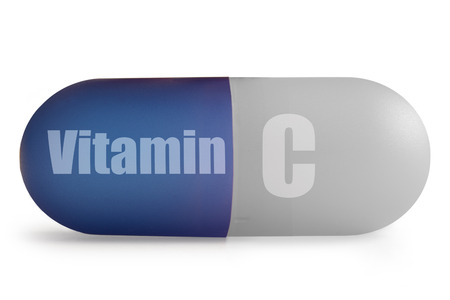 Vitamin c supplement pill over a white backgroundの写真素材